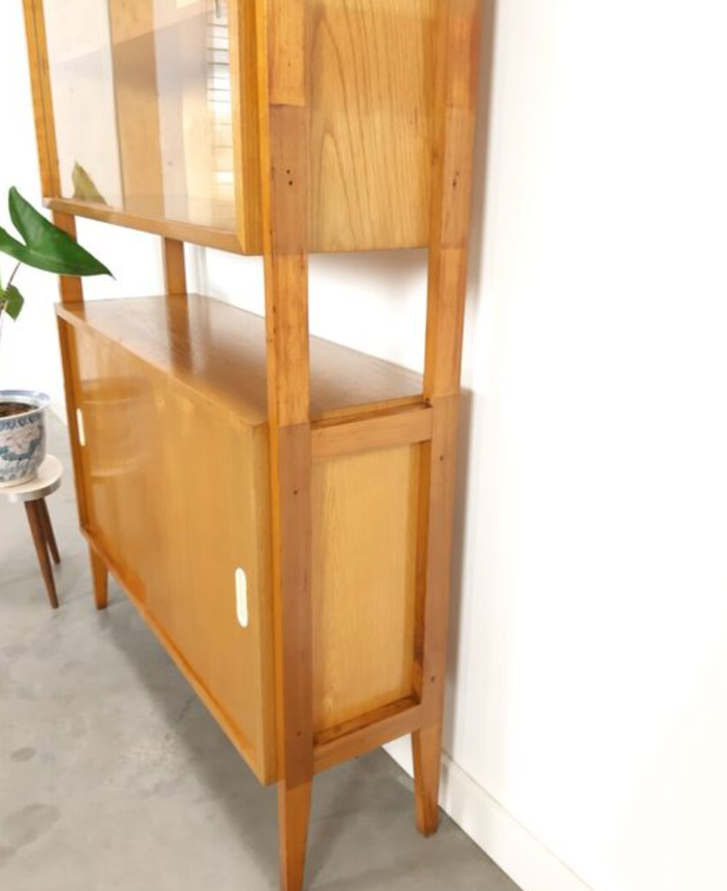 Vintage wooden showcase with sliding doors and white handles