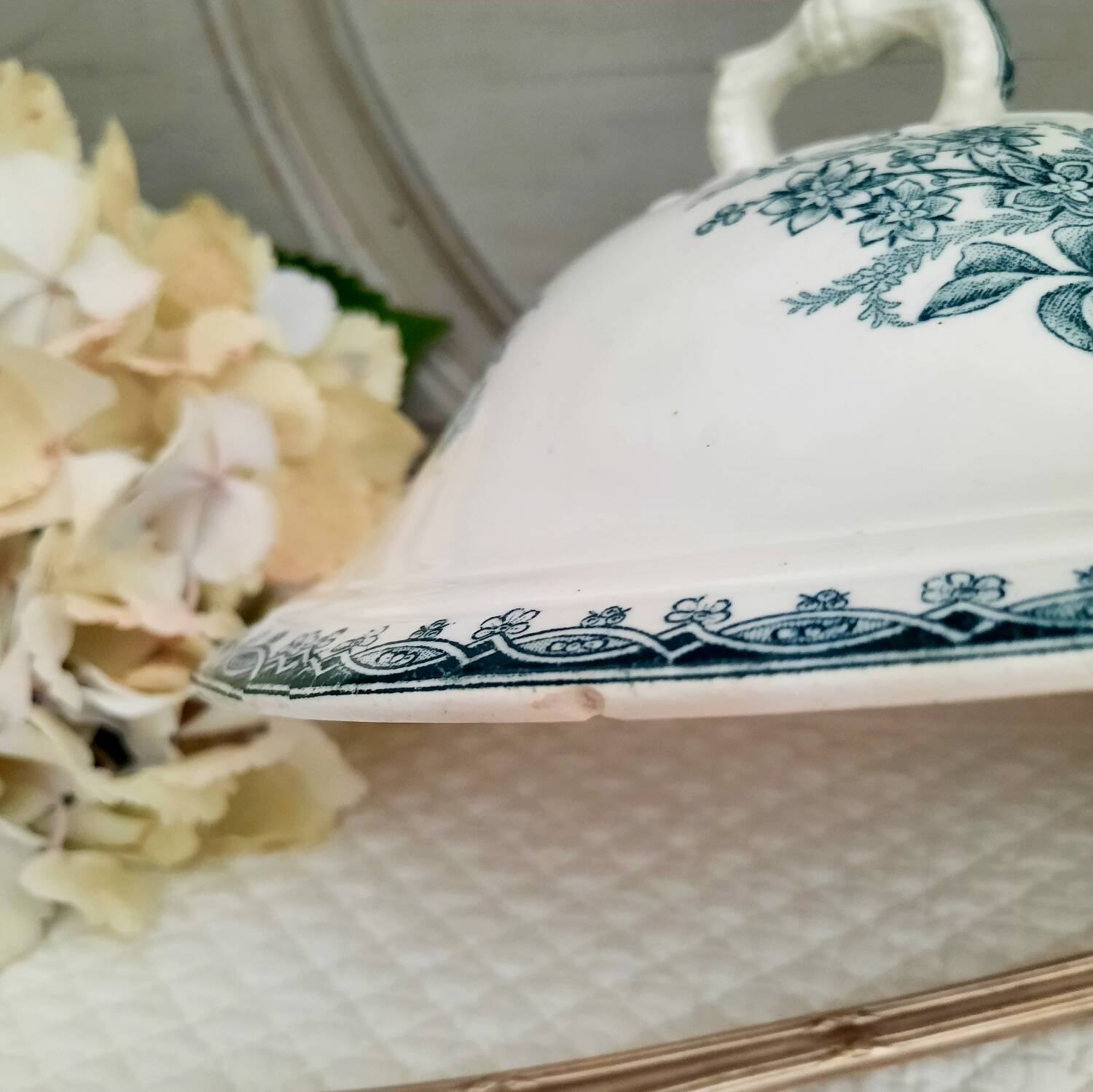 Old mismatched hollow plates in iron earth earthenware accompanied by a soup tureen