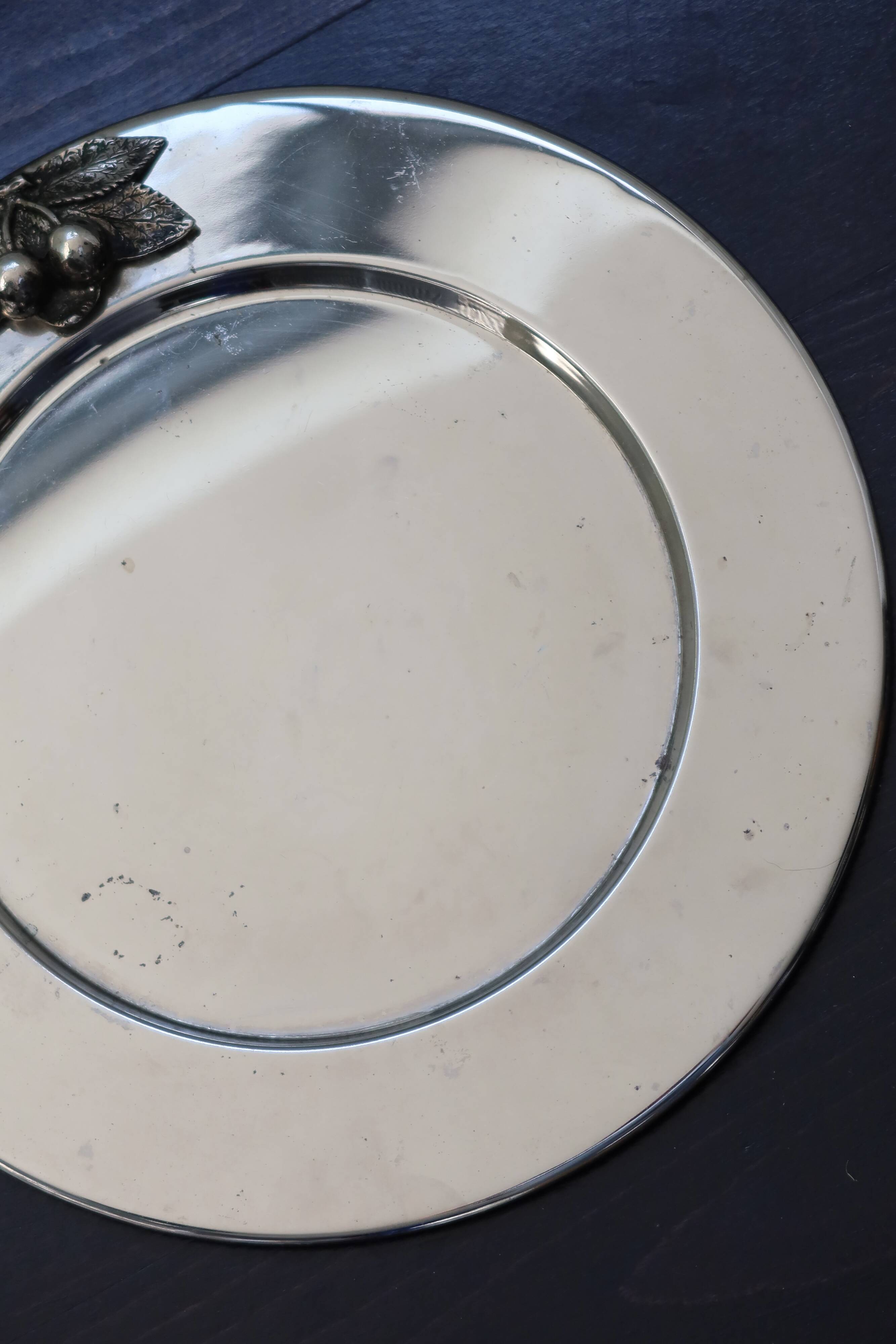 Vintage silver-plated round service tray with embossed cherries.