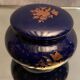 Porcelain candy box with golden floral decoration on a midnight blue background