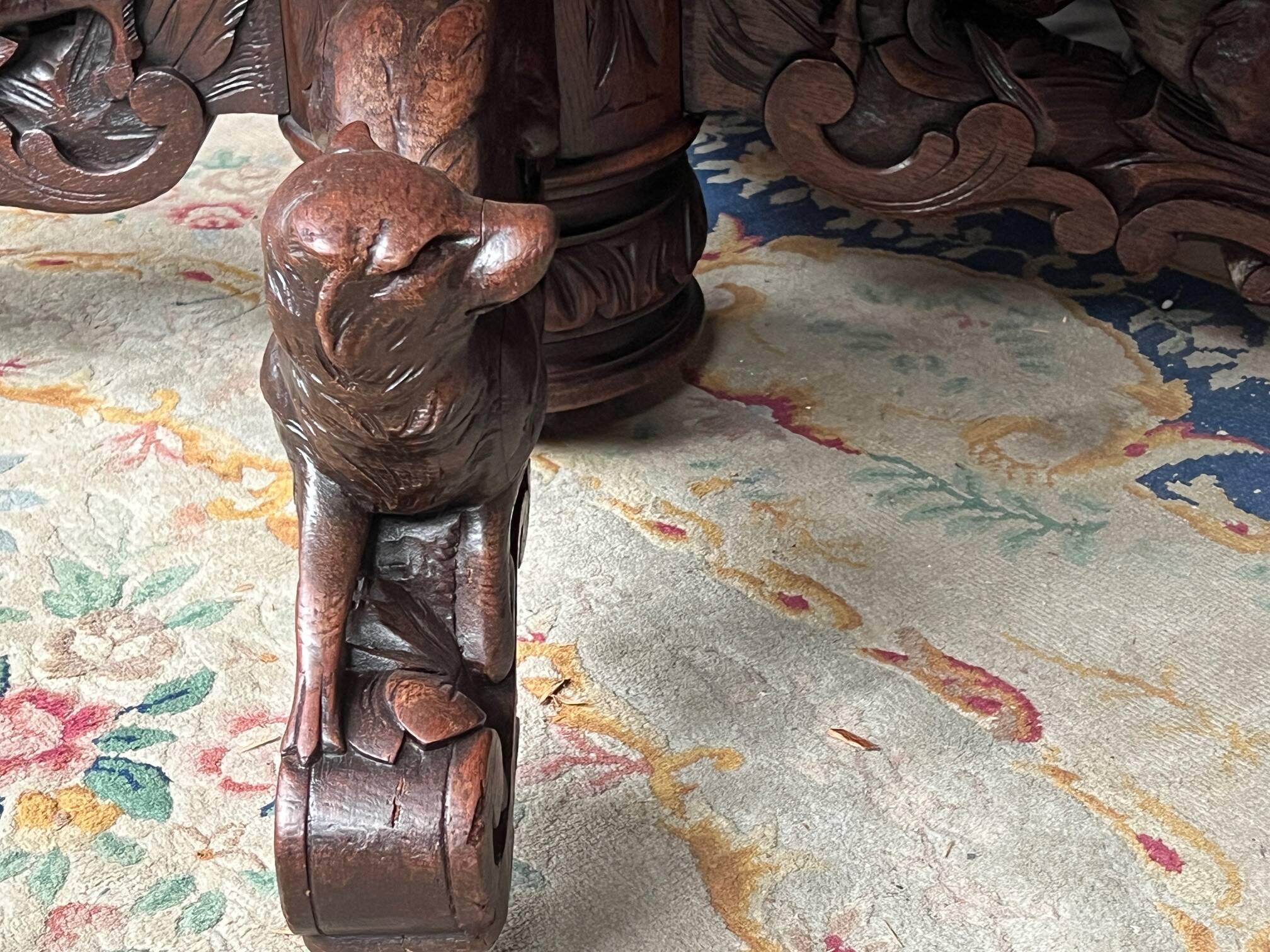 Hunting style dining table with figures of four different animals.