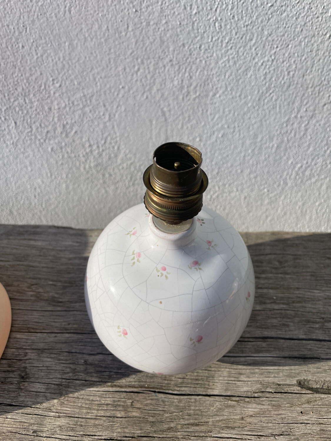Small cracked white ceramic lamp with flowers.