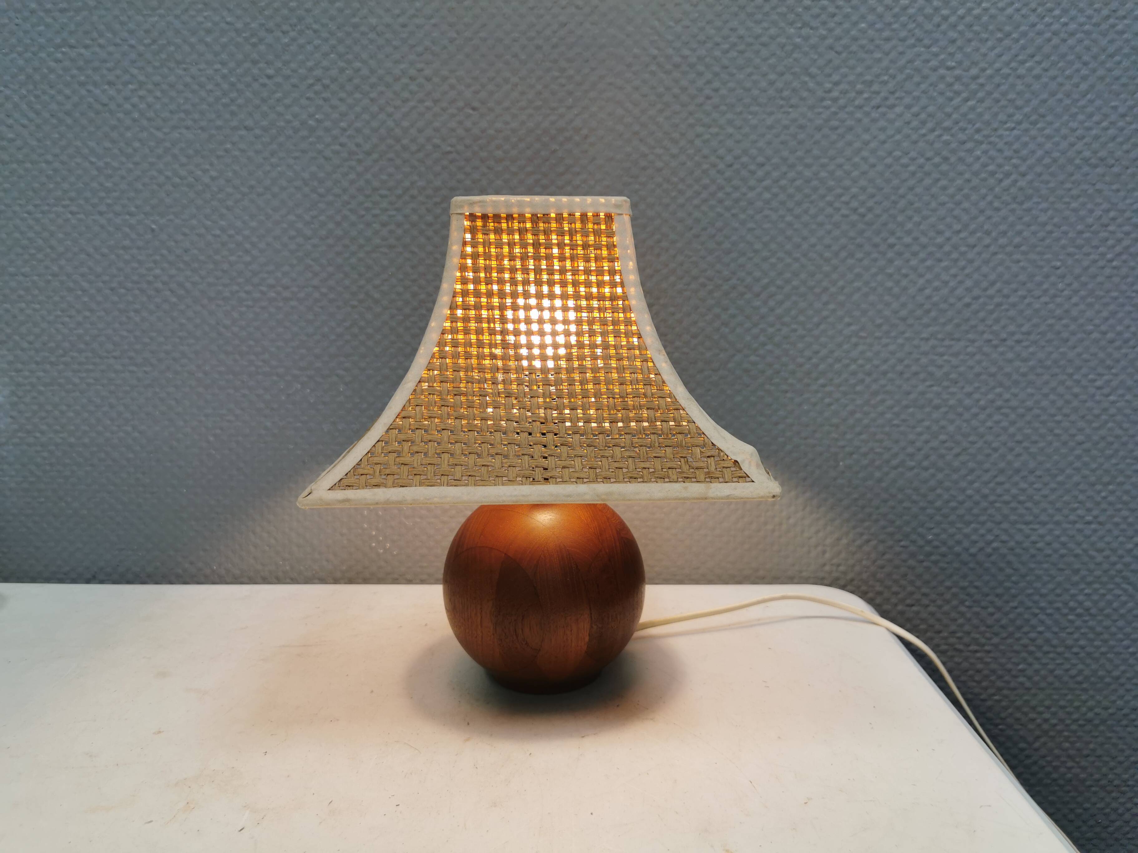 Very rare table lamp in turned teak wood with original braided shade. 1970s