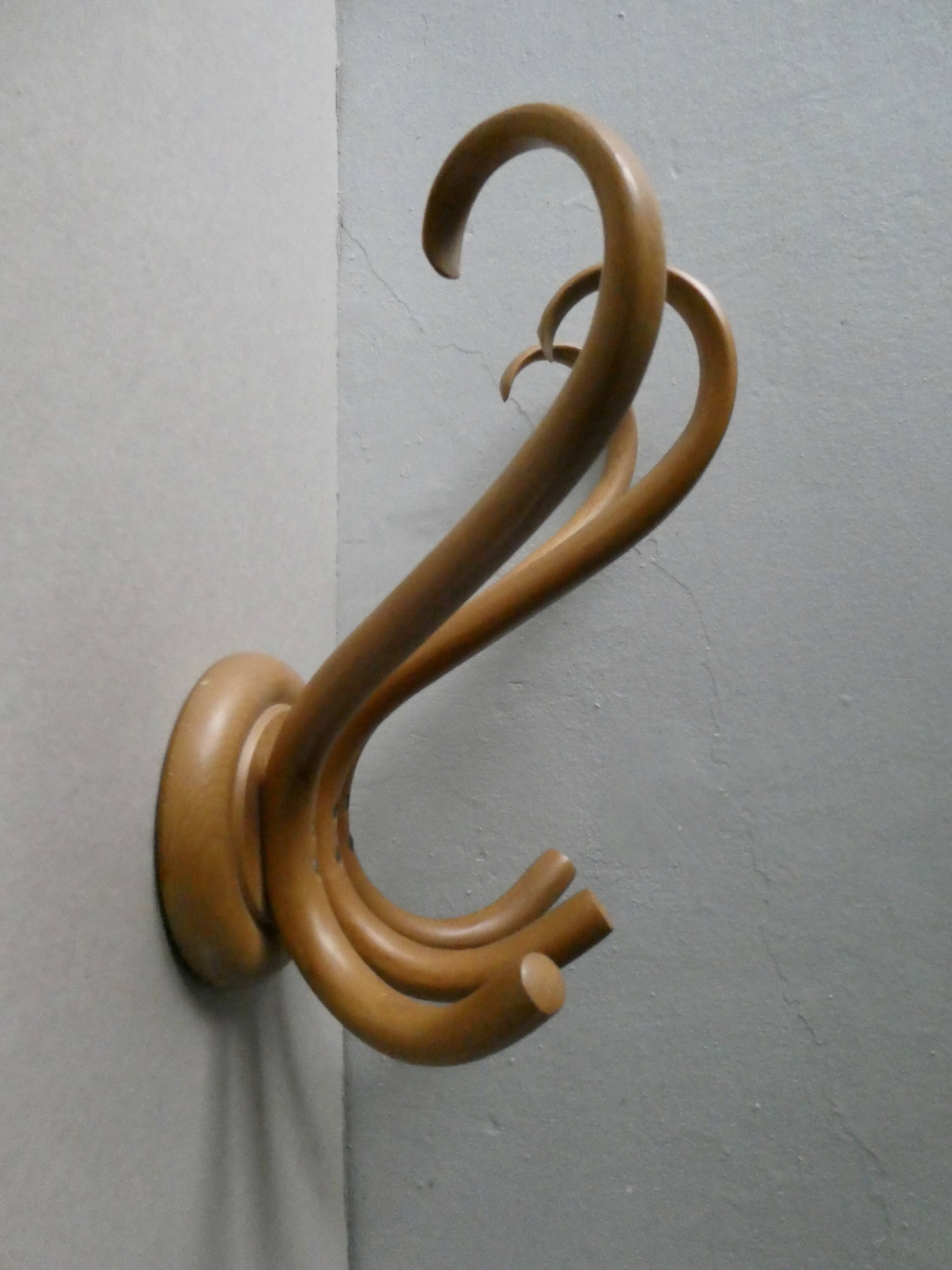 Bistro coat holder with curved wooden pads