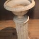 Column topped with a plaster basin.