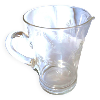 Blown glass pitcher decorated with small flowers