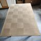 Oak dining table with a checkerboard top and extensions.