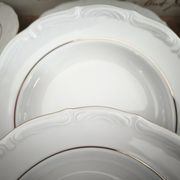 12 deep plates in porcelain with double gold trim.