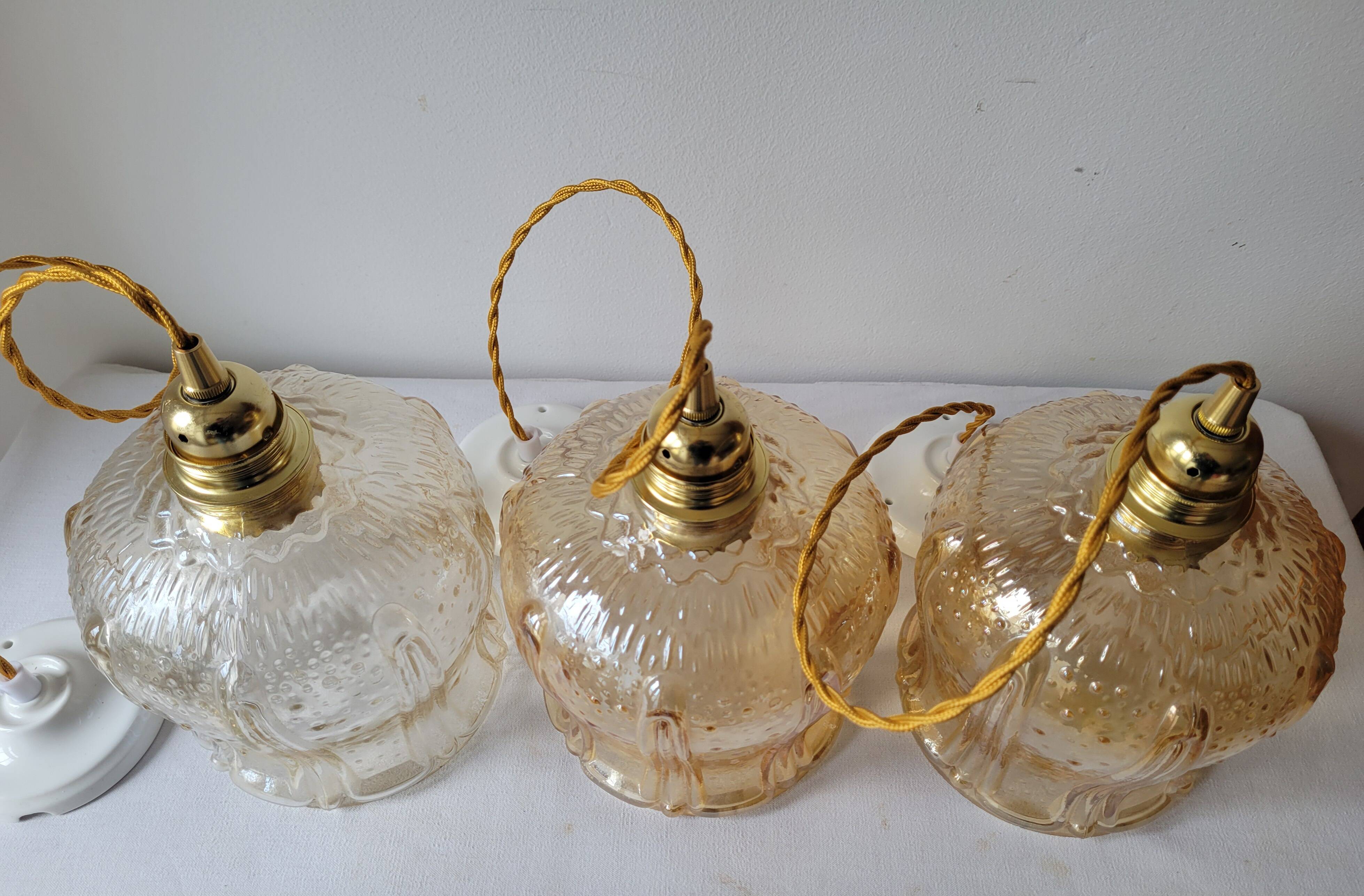 Trio of amber glass pendant lights