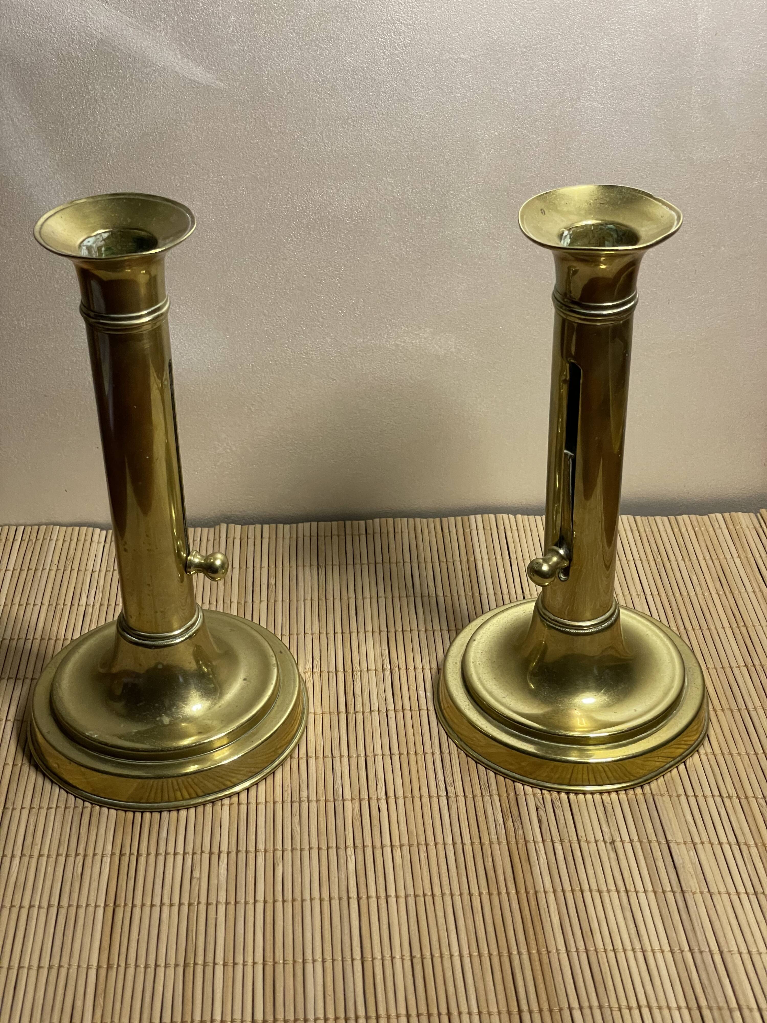 Duo of brass push candle holders