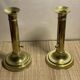 Duo of brass push candle holders