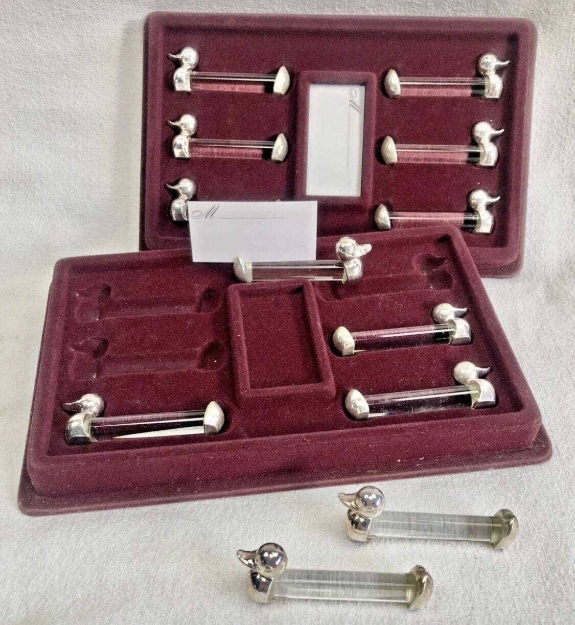 12 silver-plated metal duck knife rests with crystal.