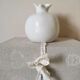 White ceramic vase in the shape of a pomegranate