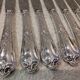 12 silver-plated dessert knives by St Medard, rocaille style, Florian.
