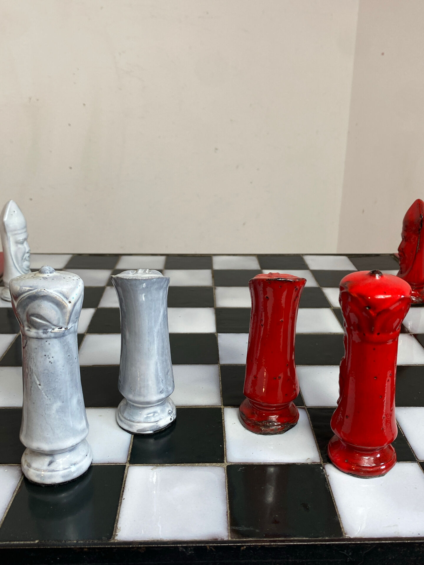 Chess set with ceramic board and pieces.