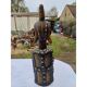 African statue of a woman, made of wood, brass, beads, and seashells.