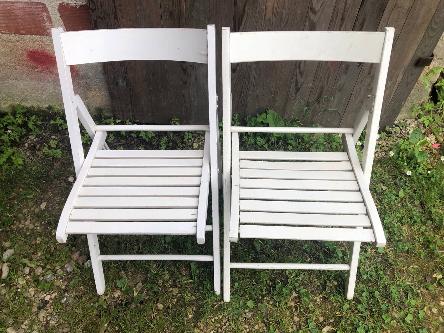 Pair of vintage white wooden folding chairs