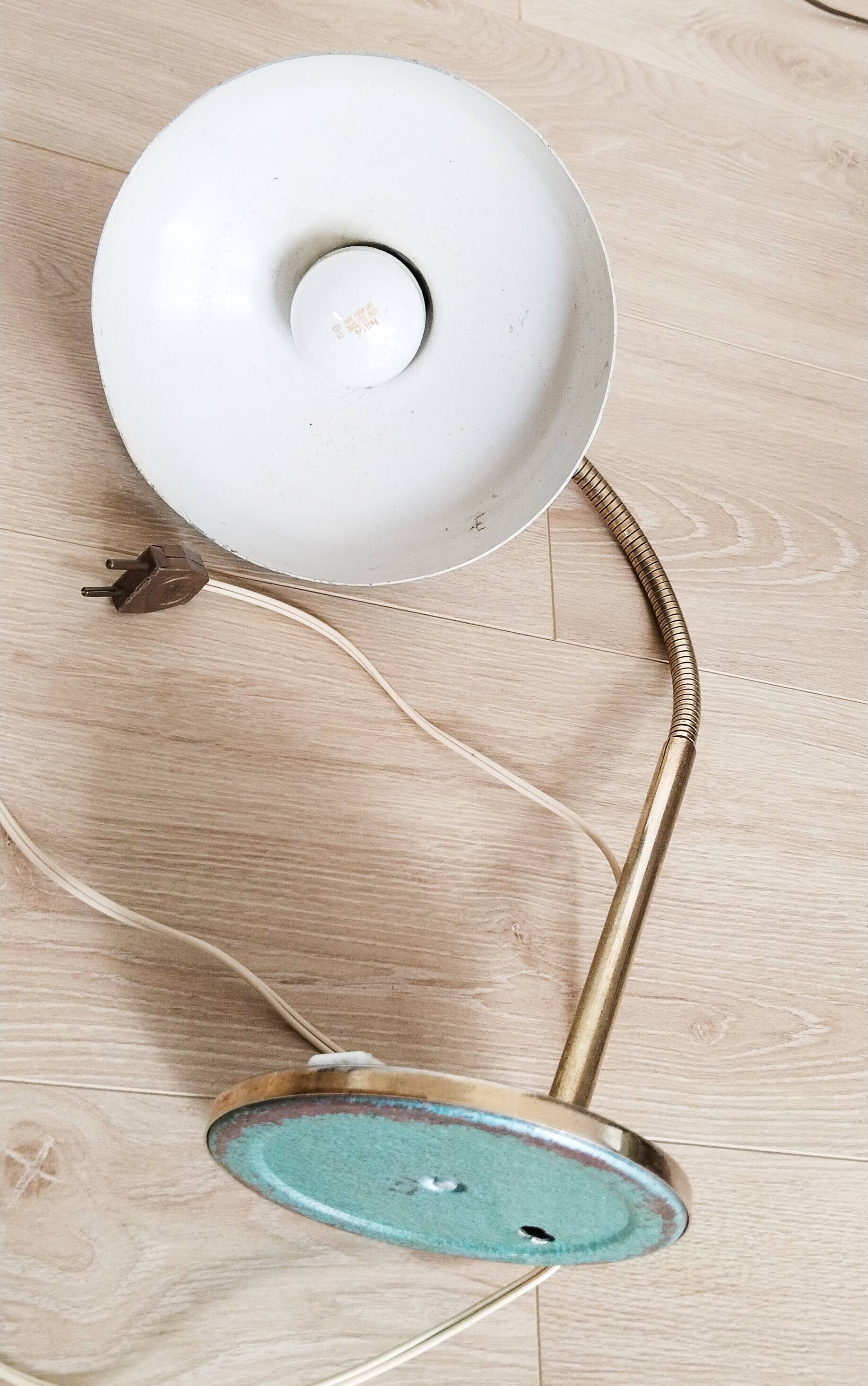 Green and gold articulated desk lamp