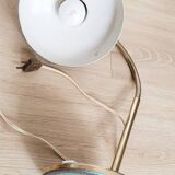 Green and gold articulated desk lamp