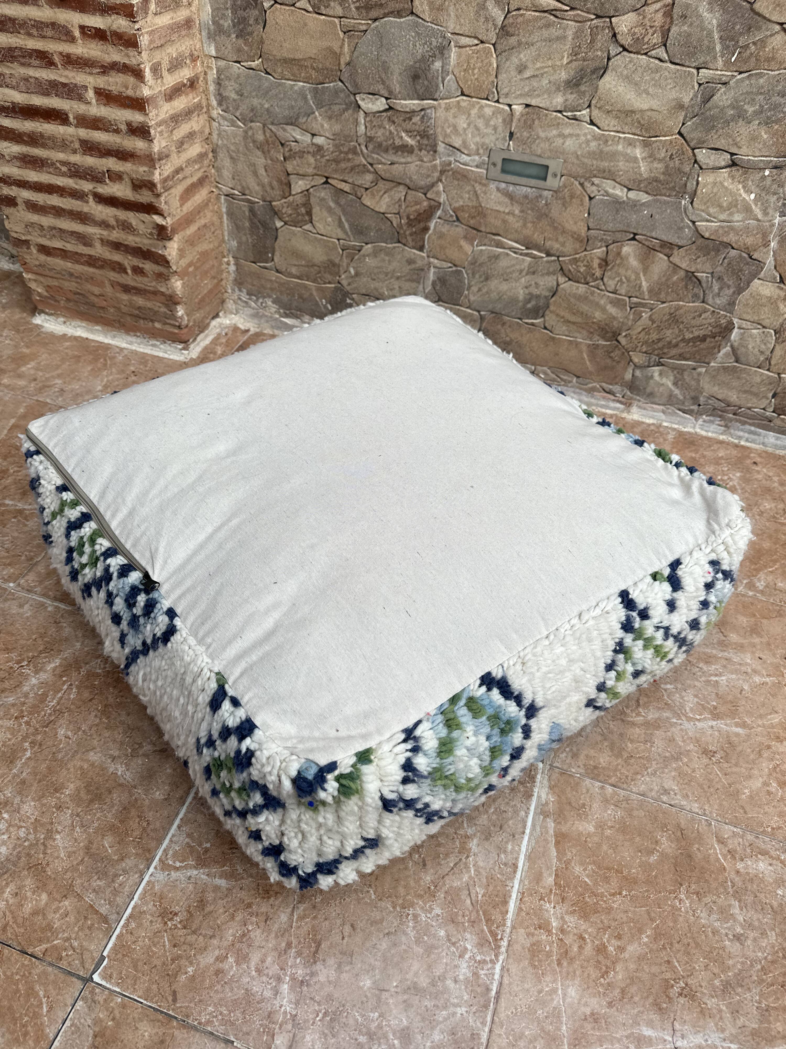 Berber floor pouf: Handwoven Moroccan wool cushion.