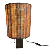 Small modernist table lamp with hand-woven shade.
