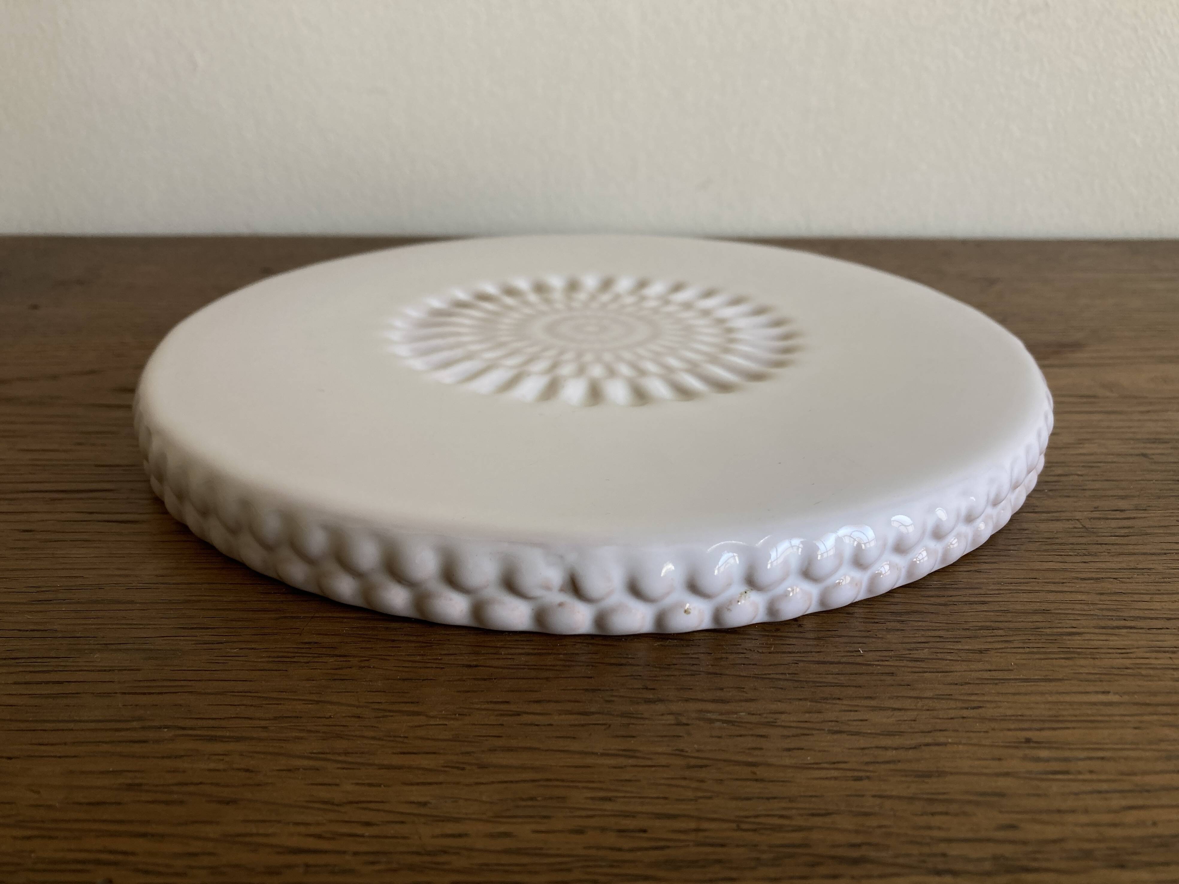 Pierre Motton glazed earthenware scalloped trivet for Gien