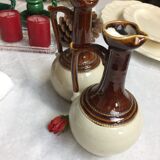 Antique handmade pitchers in beige and brown enamelled terracotta
