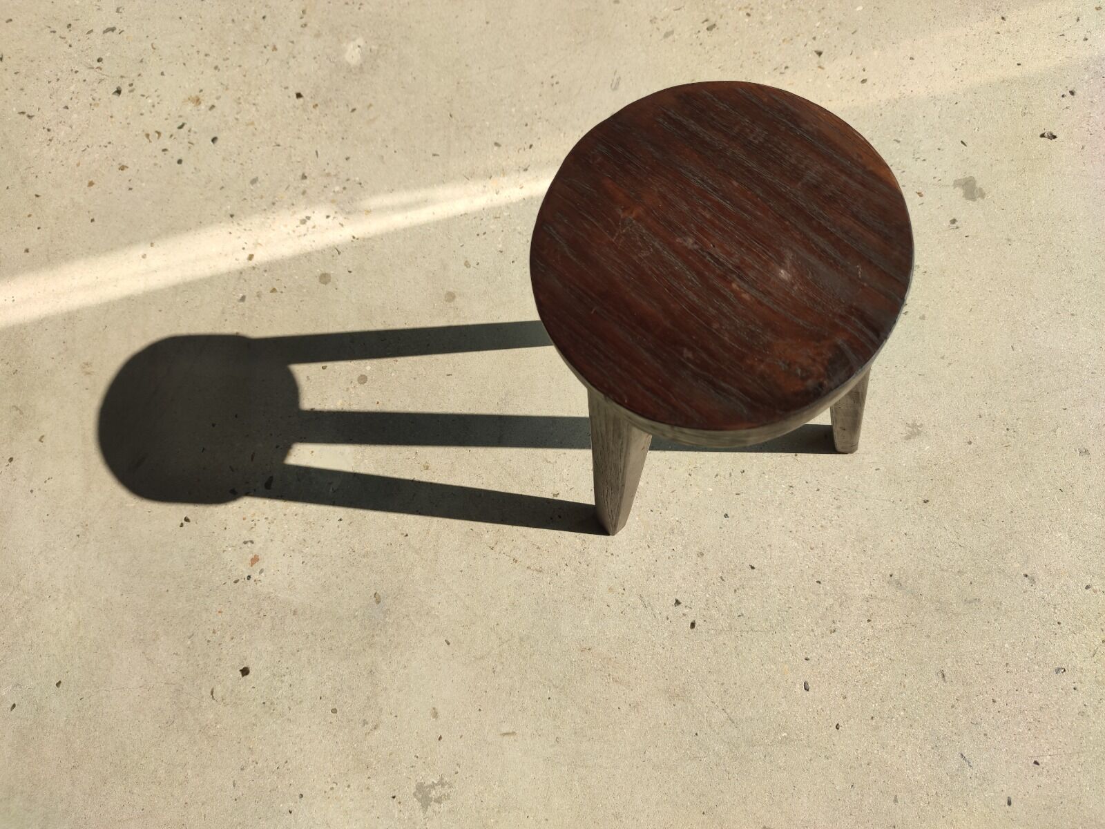 Small high tripod stool in brown solid wood