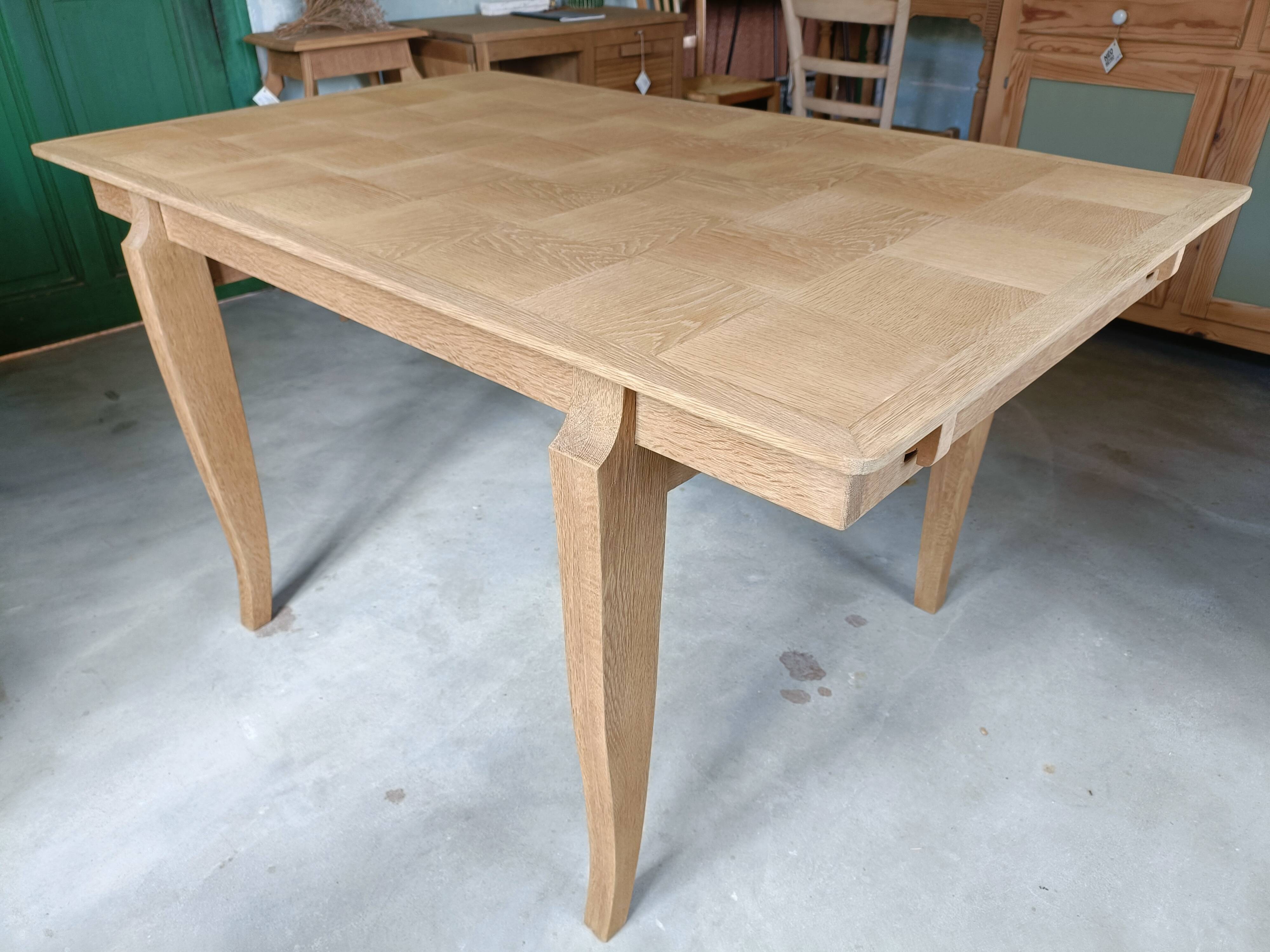 Oak dining table with a checkerboard top and extensions.