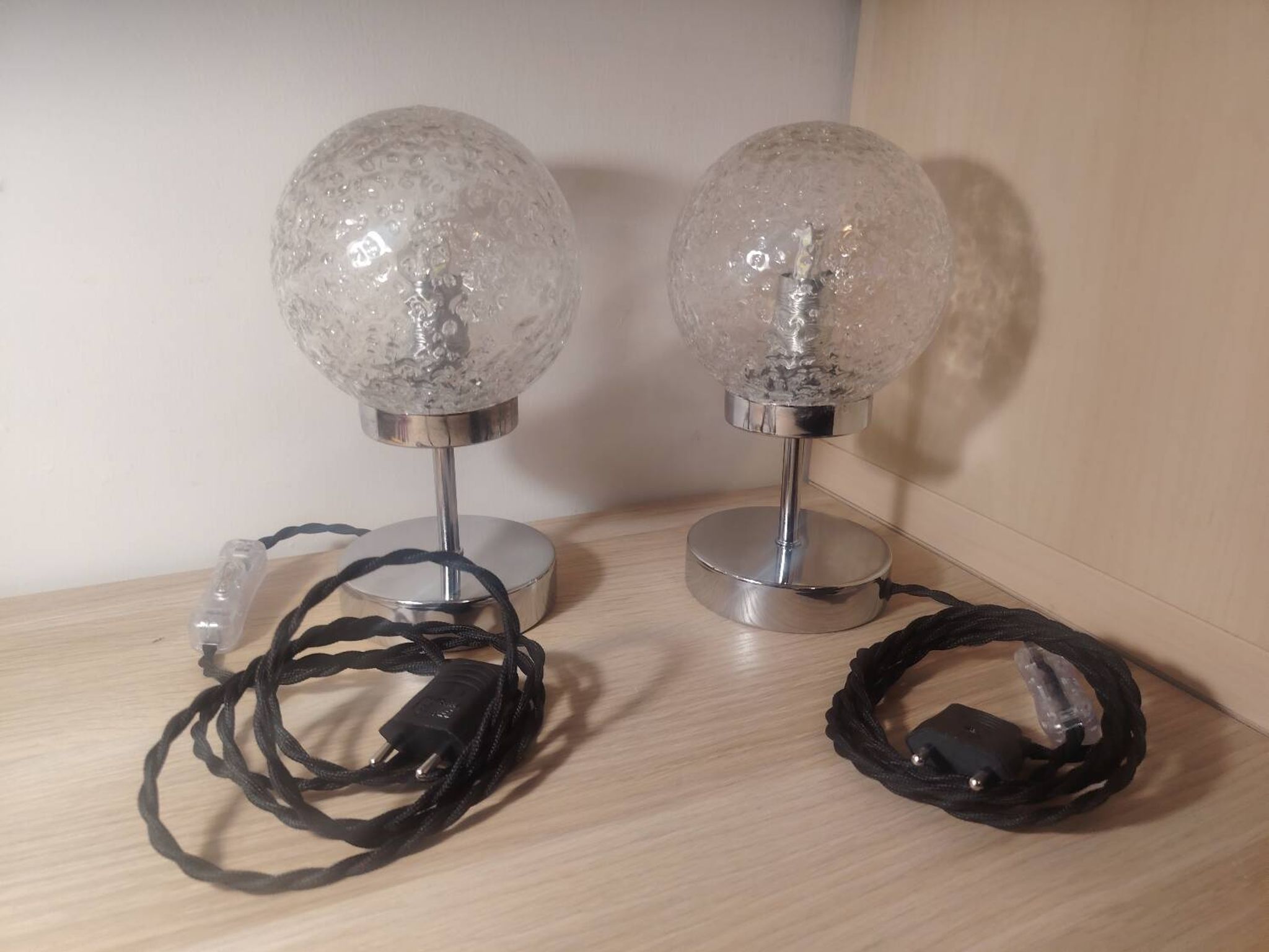 Duo of textured globe lamps with a large play of light.