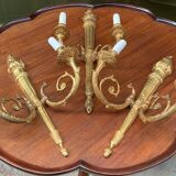 Set of three Empire-style candlesticks.