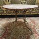 Wrought iron garden table with round top