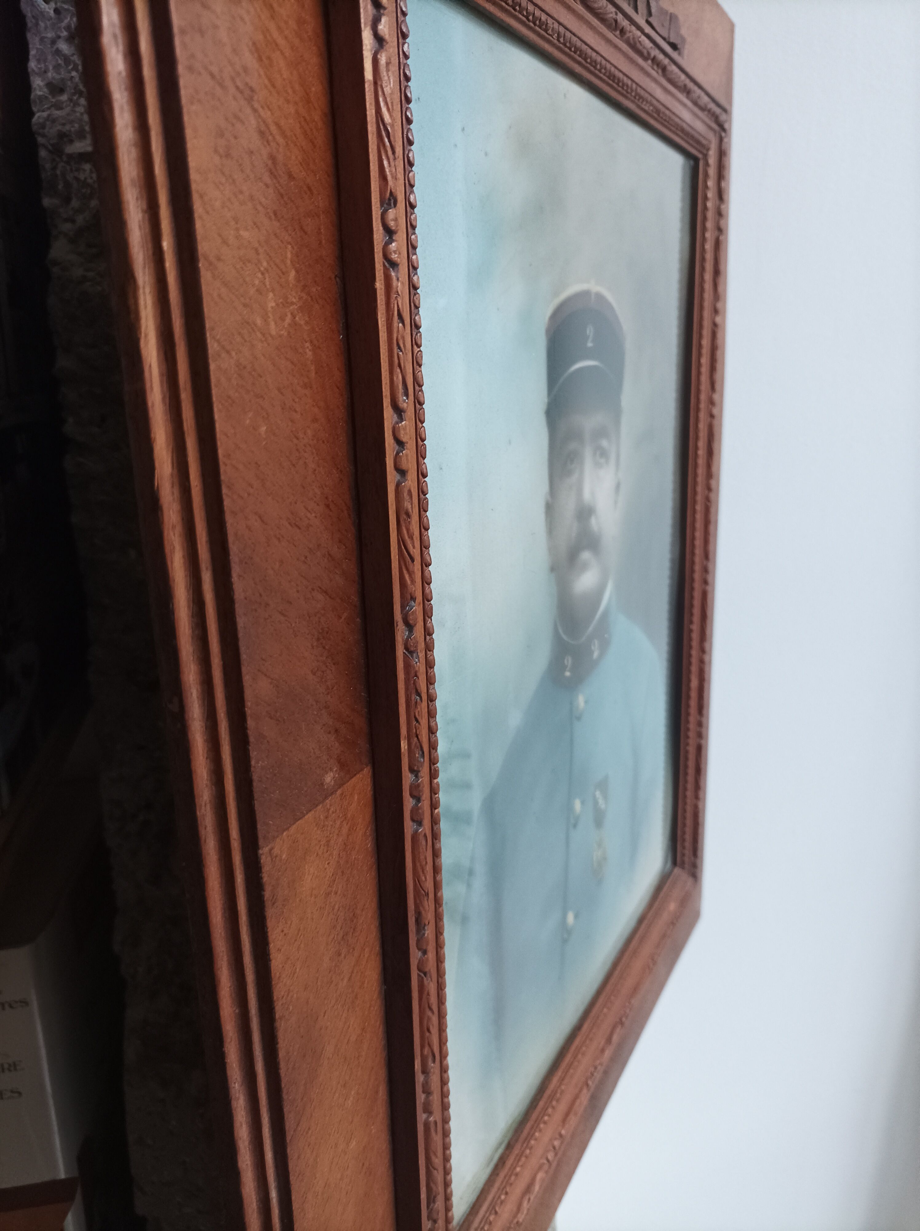Antique wooden frame with carved portrait knot