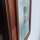 Antique wooden frame with carved portrait knot