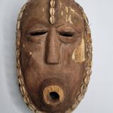 Decorative African mask in carved wood and cowrie shells, Baoulé style, 34 cm
