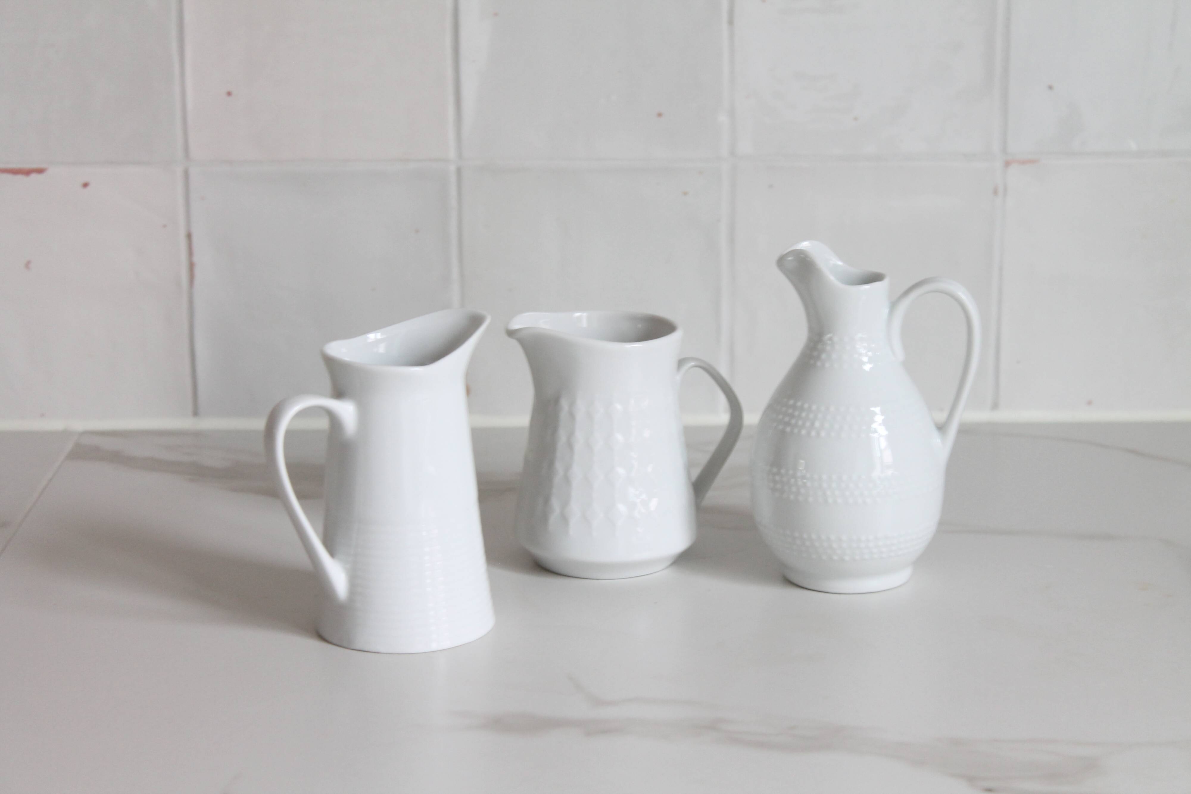3 old French pitchers in white ceramic