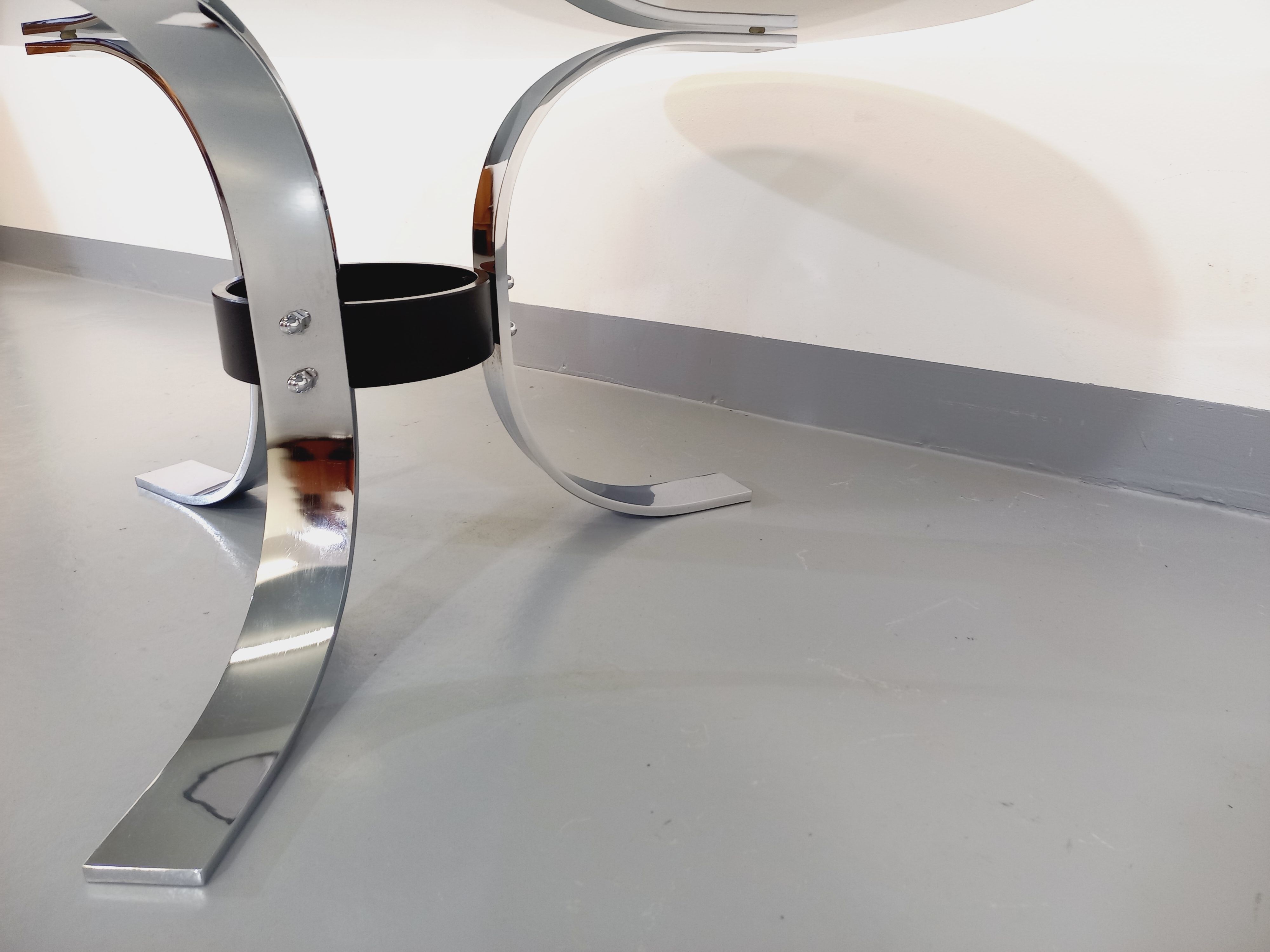 Vintage round coffee table in glass, chromed metal and black metal Space Age style of the 70s