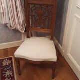 Prie-god furniture in the shape of a low seat with an armnedle on which one kneels to pray