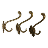 Three old and beautiful brass hooks with decorative motifs