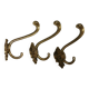 Three old and beautiful brass hooks with decorative motifs