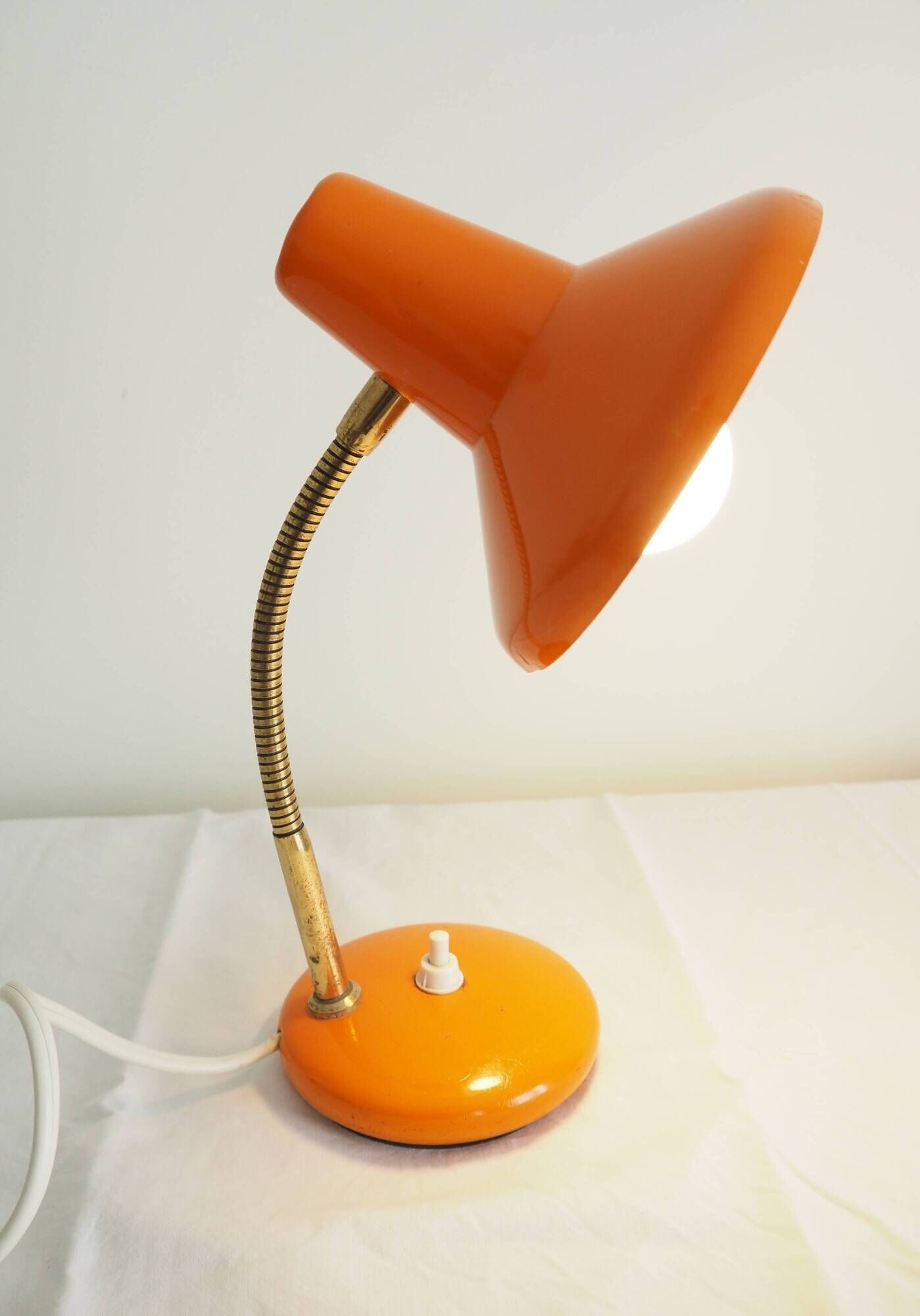 Orange colored metal desk lamp from the 1960s-1970s