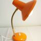 Orange colored metal desk lamp from the 1960s-1970s