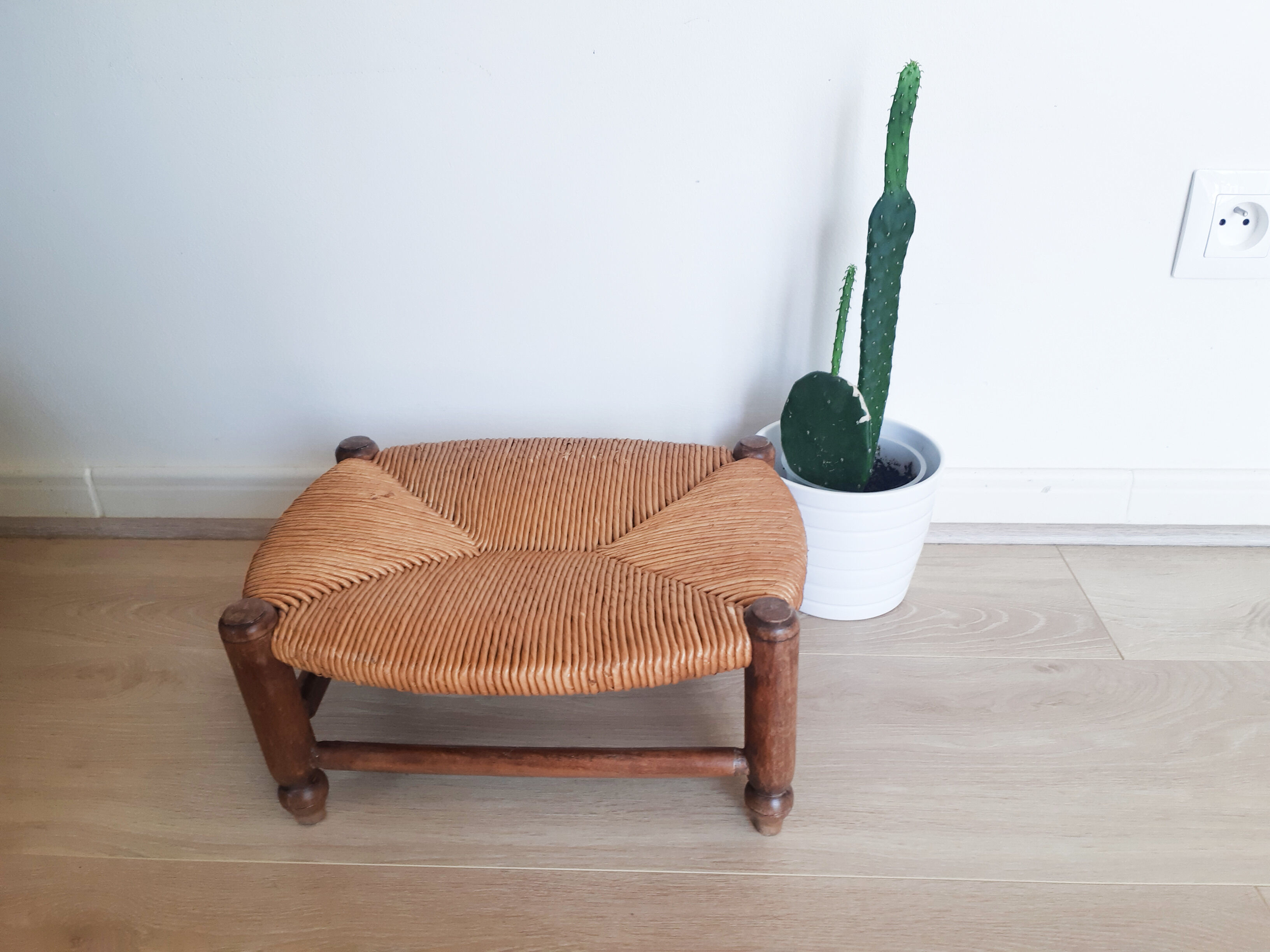 Low wooden stool and straw
