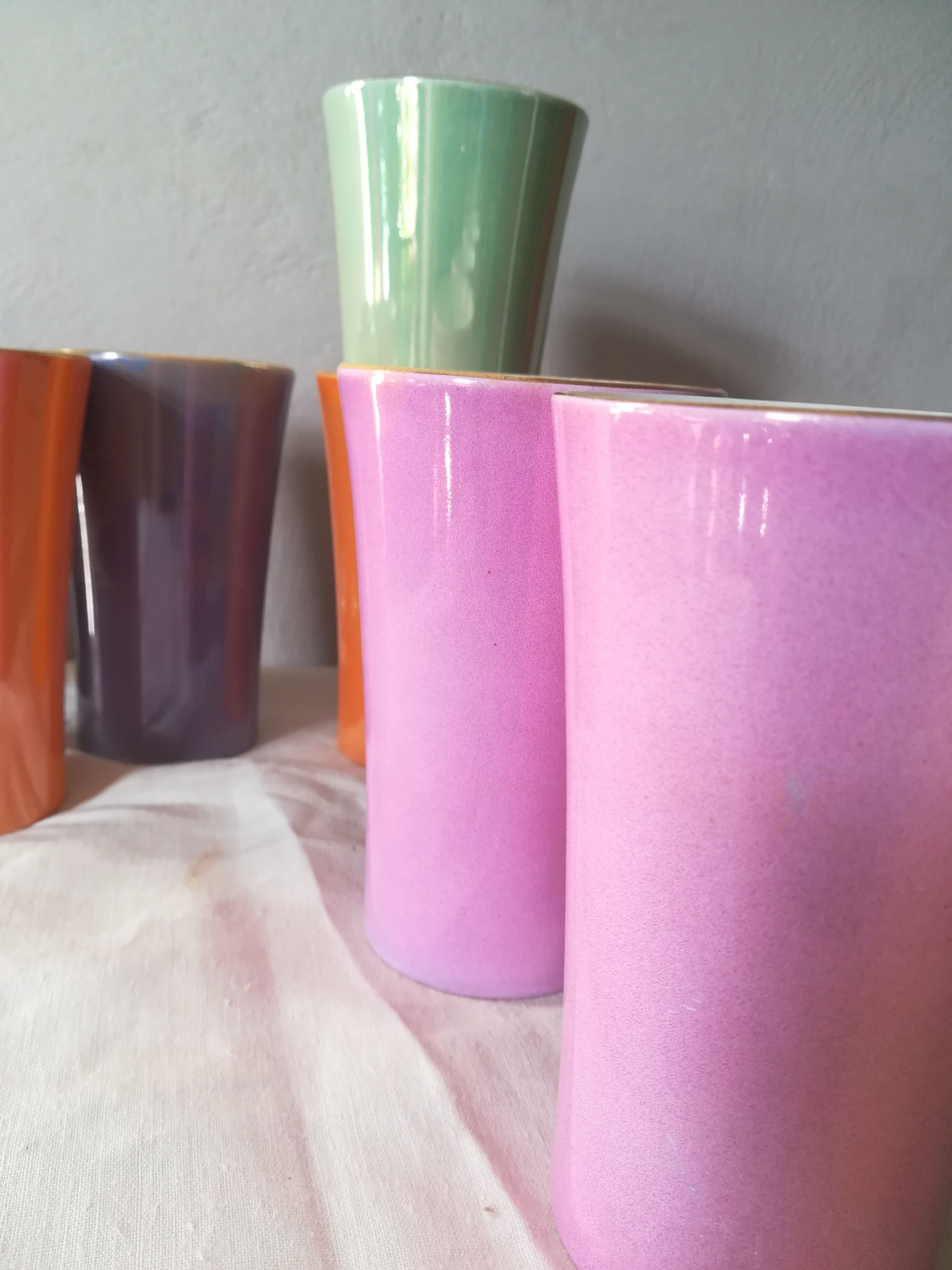 8 coloured cups in earthenware