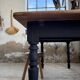 Oak farmhouse table with turned black legs.