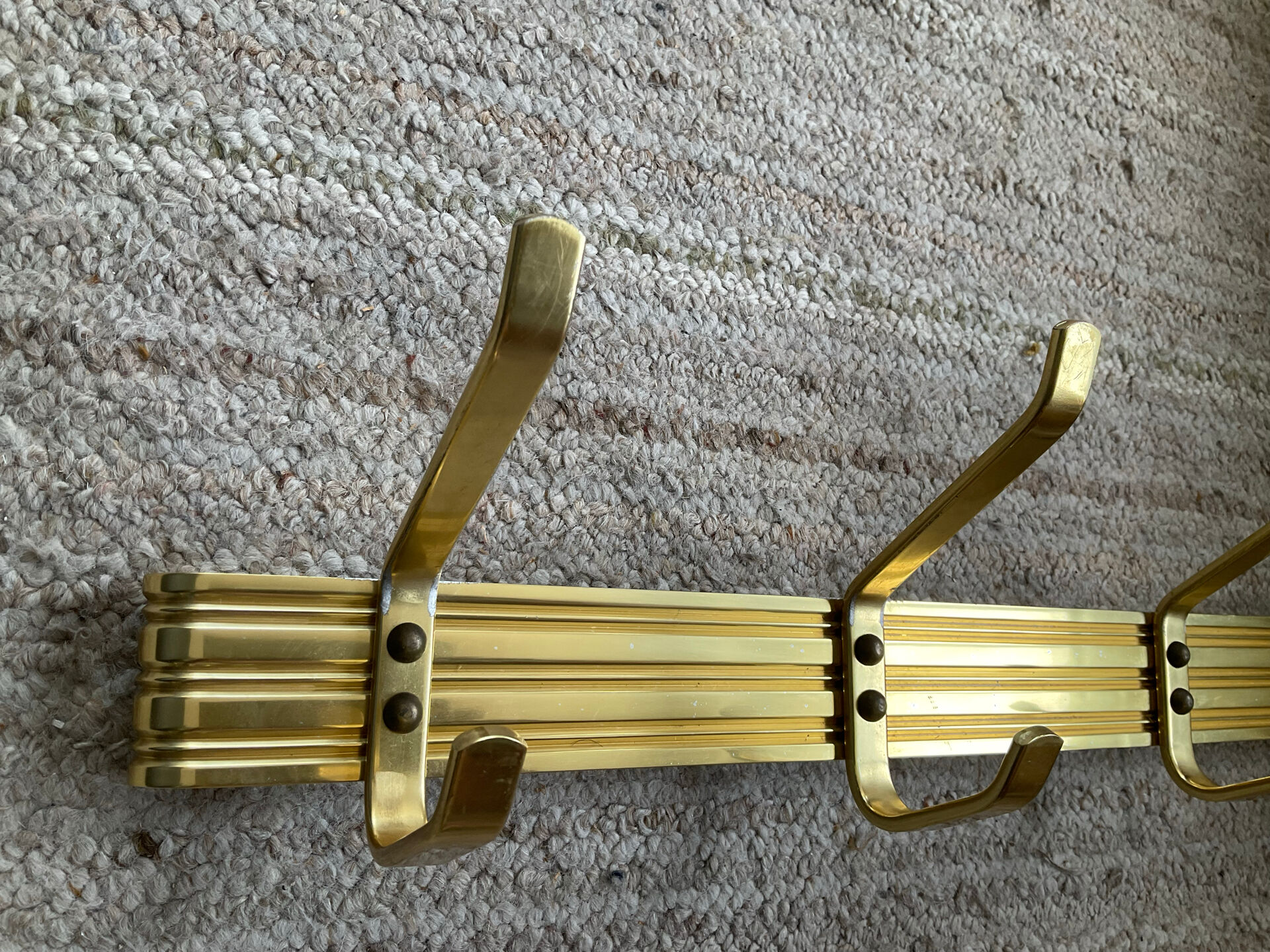 Golden wall-mounted coat rack from the 70s.