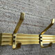 Golden wall-mounted coat rack from the 70s.