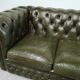 Three-seater green leather Chesterfield sofa