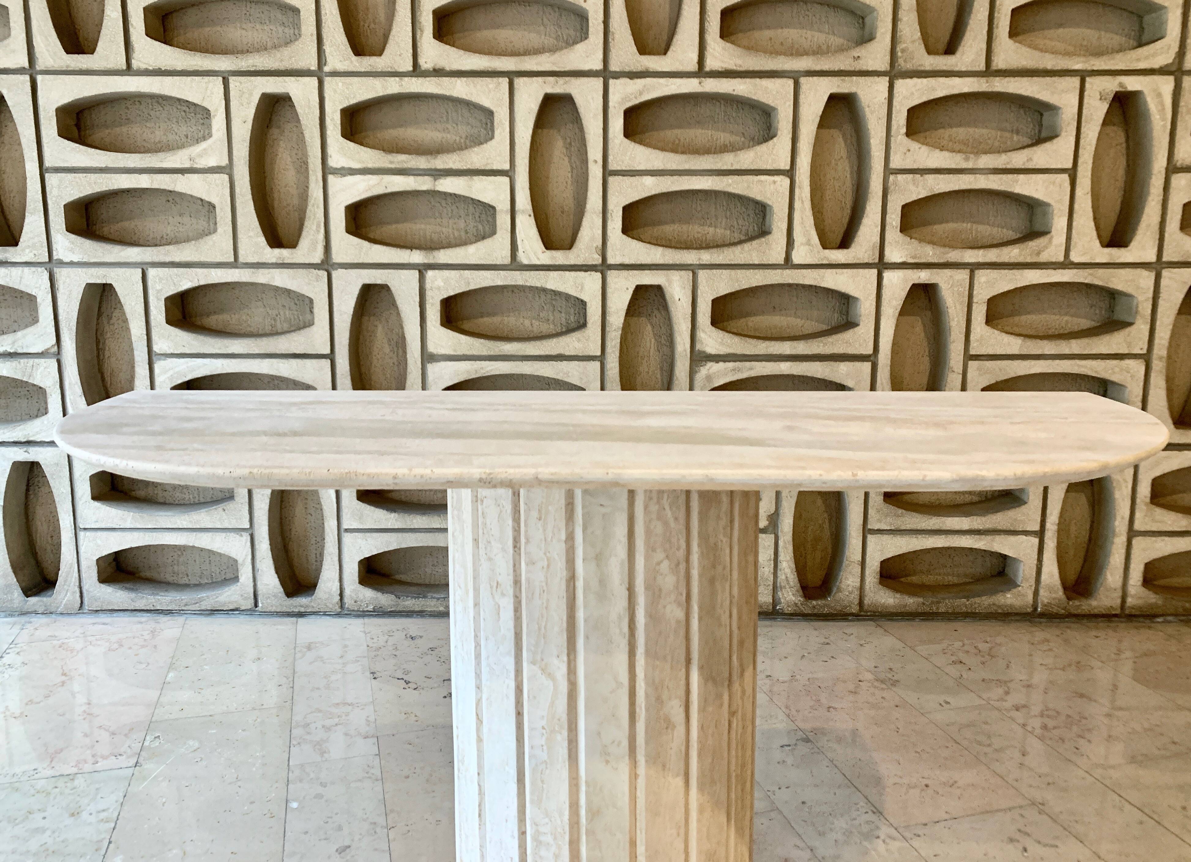 Travertine console with canted foot