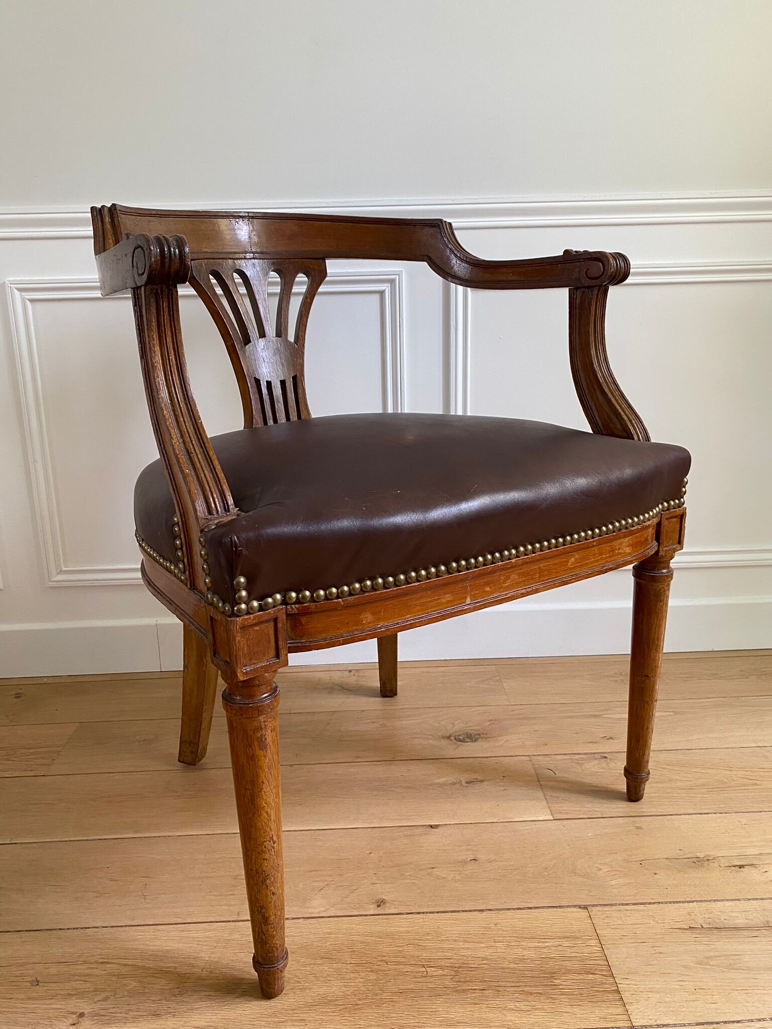 Vintage office chair in wood and brown studded leather late nineteenth